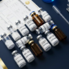 esearch peptide vials and Certificate of Analysis documents on dark laboratory surface — UK peptide supplier guide 2026